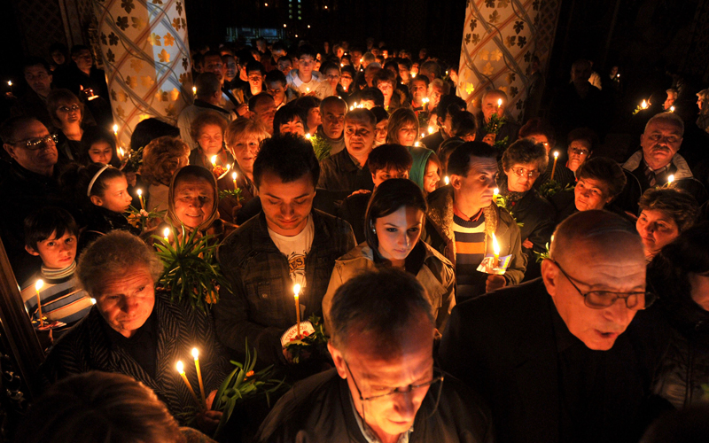Christian Orthodox believers with candles attend an Easter service in St. Trinity church in town of Radovis, southeastern Macedonia. (AP)