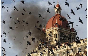 <p>In this photograph taken on November 27, 2008, flames gush out of The Taj Mahal Hotel in Mumbai, one of the sites of attacks by alleged militant gunmen. (AFP)</p>