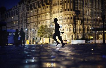 <p>In this November 29, 2008 file photo, an Indian soldier runs to take cover in front of the Taj Mahal hotel as Indian troops and militants battle in Mumbai, India (AP)</p>