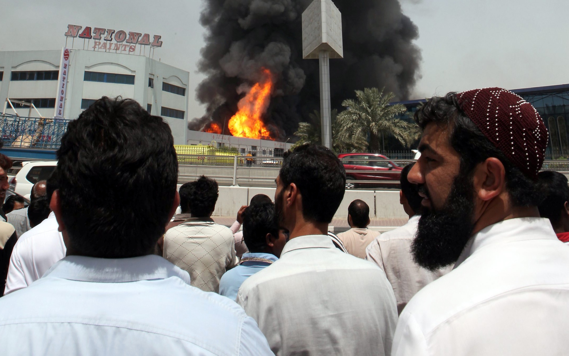 Residents watch as a massive fire breaks out at the National Paints Factory in Sharjah. Almost all roads leading to Dubai and Ajman from Sharjah have been closed due to safety measures on May 11, 2010. (SATISH KUMAR)