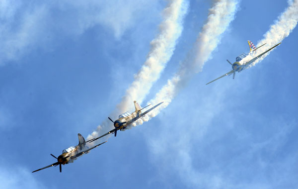 Romanian pilots fly their IAK52 airplanes during an aerobatic demonstration at the Otopeni Air Show 2010, near Bucharest. (AFP)