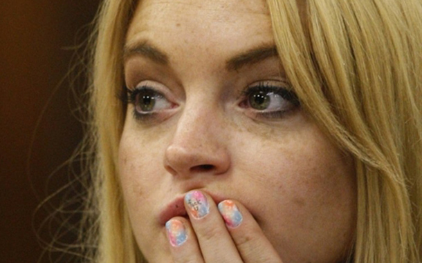 Lindsay Lohan sits with a message written on her fingernail before she is sentenced to 90 days jail by Judge Marsha Revel during her hearing at the Beverly Hills Courthouse. She sobbed and pleaded in court not to be thrown in jail, but troubled Hollywood starlet Lindsay Lohan had another, far less plaintive message for the judge, written on the fingernail of her middle finger. Photographers using telephoto lenses captured photos showing that Lohan, hand pressed against her mouth, had a few words carefully written over a multicolored pastiche of pastel nail polish. The judge ordered Lohan, 24, to spend 90 days in jail for violating probation in two 2007 drunken driving cases. She also was ordered to take part in a 90-day in-patient substance abuse program. (AFP)
