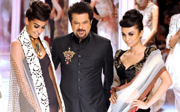 Bollywood Actor Anil Kapoor, centre, poses with models as he presents a creation by designer Anamika Khanna during the Pearls Delhi Couture Week. (AFP)