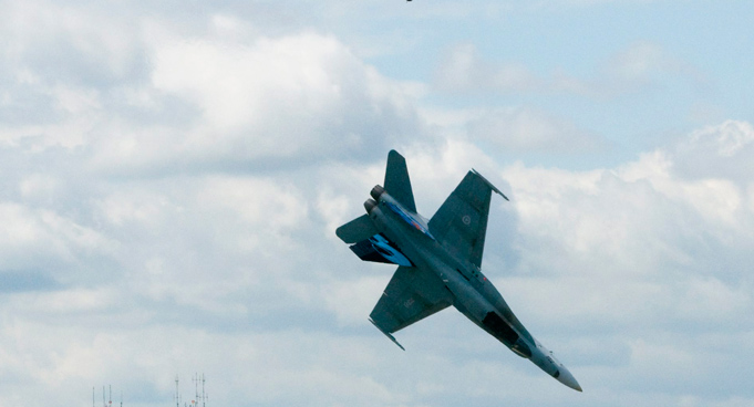 Pilot Capt. Brian Bews parachutes to safety as his a CF-18 fighter jet plummets to the ground during a practice flight at the Lethbridge County Airportr. The weekend airshow in Lethbridge, Alberta, Canada. (AP)