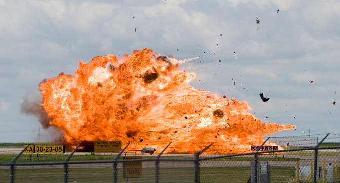 A CF-18 fighter explodes after crashing during a practice flight at the Lethbridge County Airport on the weekend airshow in Lethbridge, Alberta, Canada. Pilot Capt. Brian Bews ejected and parachuted down before the impact. (AP)