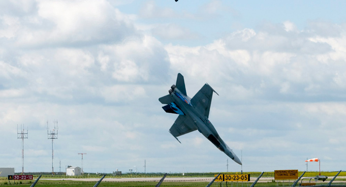 Pilot Capt. Brian Bews parachutes to safety as his a CF-18 fighter jet plummets to the ground during a practice flight at the Lethbridge County Airport on  the weekend airshow in Lethbridge, Alberta, Canada. (AP)