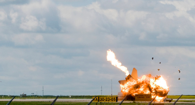 Pilot Capt. Brian Bews parachutes to safety as his a CF-18 fighter jet crashes and explodes during a practice flight at the Lethbridge County Airport on the weekend airshow in Lethbridge, Alberta, Canada. (AP)