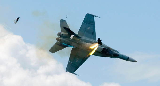 Pilot Capt. Brian Bews ejects as his a CF-18 fighter jet plummets to the ground during a practice flight at the Lethbridge County Airport on the weekend airshow in Lethbridge, Alberta, Canada. (AP)