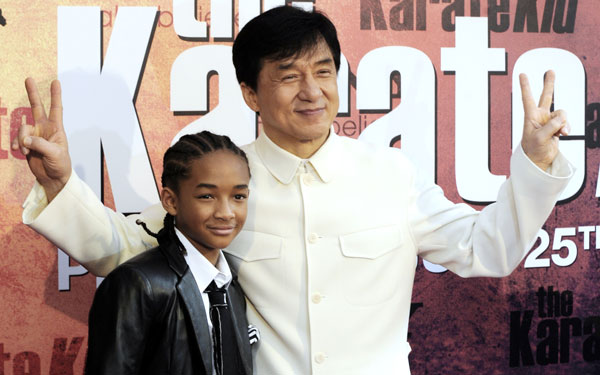 Chinese actor and producer Jackie Chan (C) and US actor and Will Smith's son Jaden Smith pose for photographers upon their arrival prior to the premiere of the film "The Karate Kid" at the Grand Rex in Paris. (AFP)