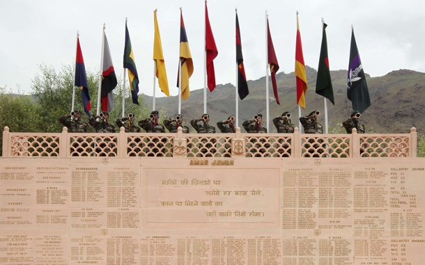 Indian soldiers blow bugles from the Kargil War Memorial in honour of the 11th anniversary of the Kargil War in the Drass sector of Ladakh, India. (AFP)