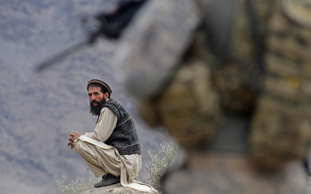 Afghan villager looks on as a US soldier from the Provincial Reconstruction team (PRT) Steel Warriors patrols in the mountains of Nuristan Province. A massive cache of leaked Pentagon documents on the Afghan war highlights the role that Pakistan's intelligence service plays in destabilising Afghanistan, the president's spokesman said. Kabul has long accused Islamabad of providing support and sanctuary for militant groups that plan, fund and carry out attacks in Afghanistan. The whistleblowing website Wikileaks made public 92,000 Pentagon files and field reports about deaths of innocent civilians, Pakistani agents meeting the Taliban and Iran secretly furnished it with money, arms and training. (AFP)