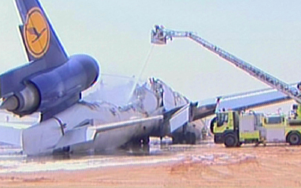 Aviation rescue teams dousing flames from a cargo plane of the German carrier Lufthansa after it crashed while landing at Riyadh airport. (AFP)