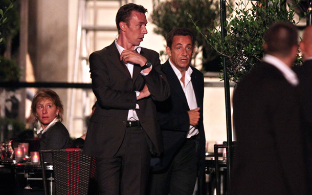 French President Nicolas Sarkozy, center right, is seen surrounded by bodyguards on the set of the movie &ldquo;Midnight in Paris&rdquo; in the French capital. (AP)