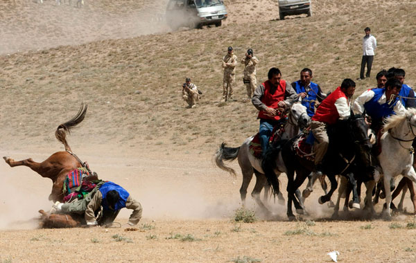 Afghan horsemen compete for the goat carcass during a game of buzkashi In Afghanistan. (GETTY IMAGES)