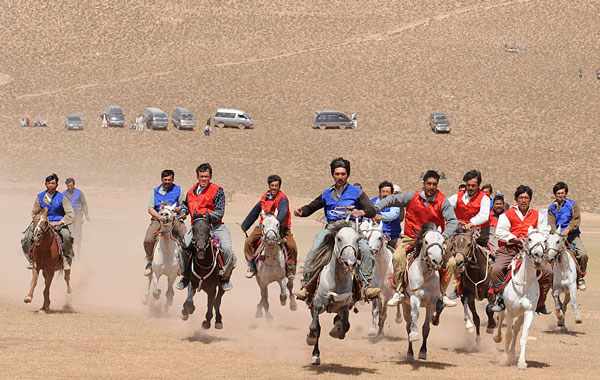 Afghan horsemen compete for the goat carcass during a game of buzkashi in Afghanistan. (AFP)