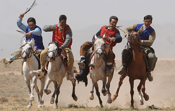 Afghan horsemen compete for the goat carcass during a game of buzkashi in Afghanistan. (AFP)