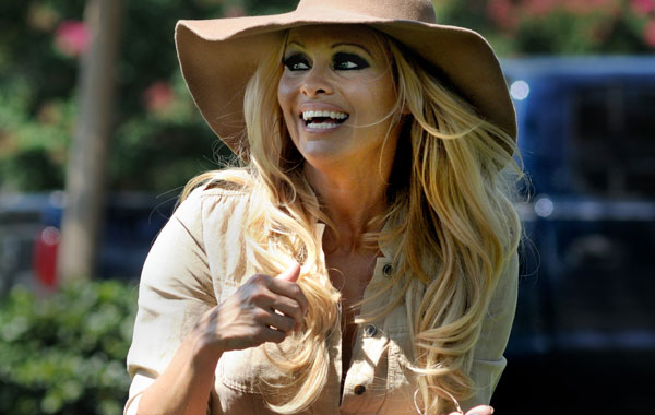 Actress Pamela Anderson takes several dogs for a walk in New Orleans. (AP)