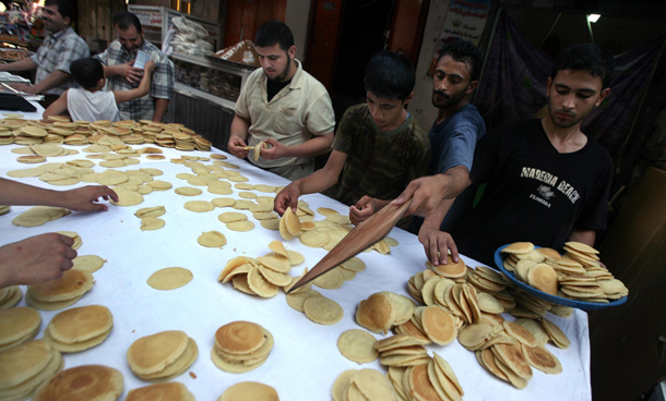 Palestinian employees making sweets for the Muslim holy month of Ramadan Gaza City, Gaza Strip. Ramadan is the ninth month of the Islamic calendar, a month of fasting, in which participating Muslims refrain from eating, drinking and sexual activities from dawn until sunset. (EPA)