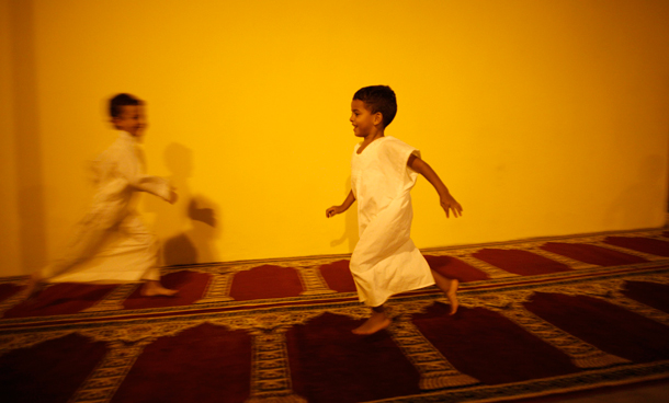 Muslim children play on a carpet on a street during the first day of Ramadan outside the mosque in the southern Spanish town of Estepona, near Malaga. Muslims around the world abstain from eating, drinking and conducting sexual relations from sunrise to sunset during Ramadan, the holiest month in the Islamic calendar. (REUTERS)