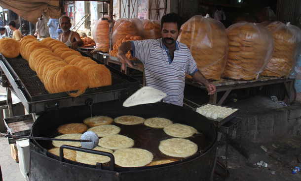 A man sells the traditional Pakistani food "Phayonian" ahead of Islam's holy month of Ramadan in Karachi, Pakistan. Muslims all over the world are observing Ramadan which prohibits food, drink, smoke and sex from dawn to dusk. (EPA)