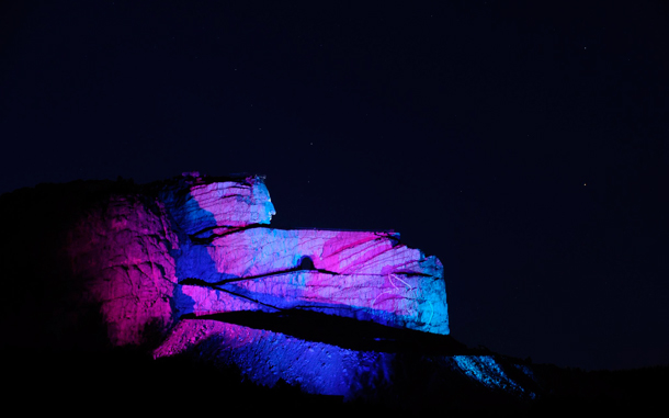 The Crazy Horse Memorial at Thunder Mountain is lit up with different colours during the laser light show in the Black Hills near Custer, South Dakota, USA. (EPA)