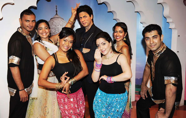 A troupe of Bollywood Axion dancers pose with the wax figure of Indian film star Shah Rukh Khan (C, rear)  at Madame Tussauds New York. (AFP)
