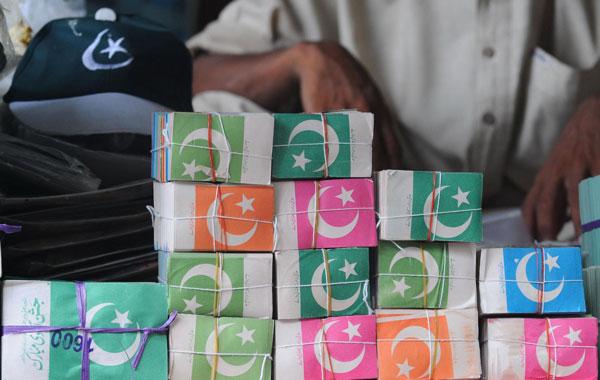 National flags are on sale at a market as nation prepares to celebrate Independence Day, in Lahore Pakistan. (EPA)