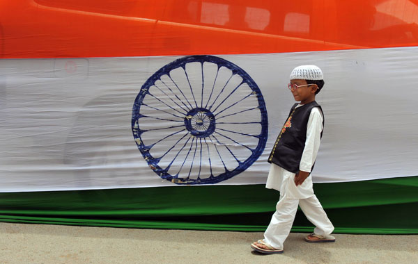 A Muslim Indian boy walks past a 400-metre long national flag set up ahead of Independence Day in Hyderabad. (AFP)