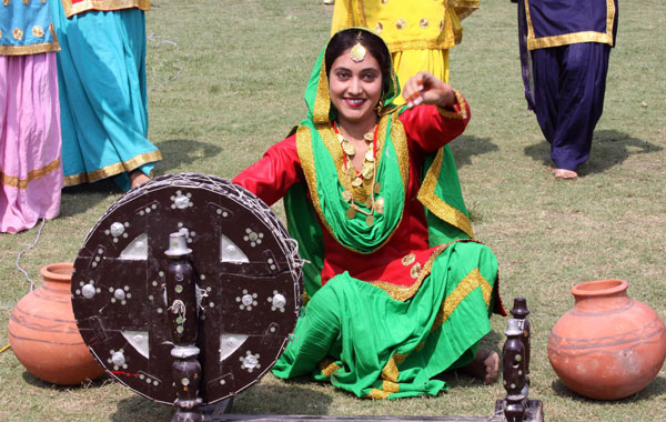 An Indian woman wearing traditional Pujabi attire performs as she takes part in full dress rehearsal for India's Independence Day celebrations and parade in Amritsar, India. (EPA)