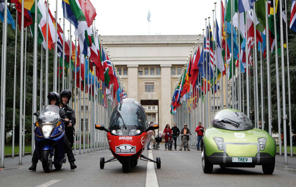 Vectrix Team (Germany) Orlikon Solar Racing Team (Switzerland) and Team Trev (Australia) pose in the flags alley before the start of the Zero Race in front of the United Nations European headquarters in Geneva. (REUTERS)