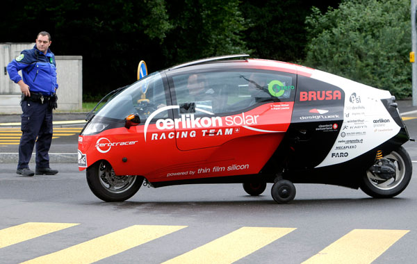 The electric vehicle of Oerlikon Solar Racing Team form Switzerland leaves the European headquarters of the United Nations after the start of the Zero Race Tour, in Geneva, Switzerland. (AP)