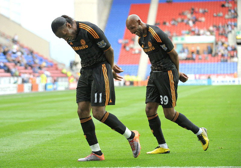 Chelsea's Nicolas Anelka (right) celebrates with Didier Drogba after scoring his side's third goal during the English Premier League match against Wigan. (AFP)