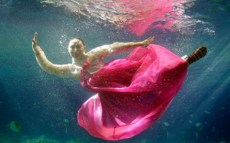 A model wears the South Korean traditional dress Hanbok, a creation by designer Park Sul-nyeo, during an underwater Hanbok fashion show in Seoul, South Korea, Sunday. (AP)