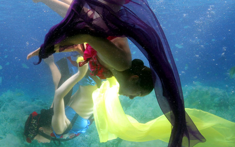 Models perform while wearing a "hankok", a traditional Korean dress, a creation by designer Park Sul-Nyeo, during the Underwater Hanbok Fashion Show in Seoul. (AFP)