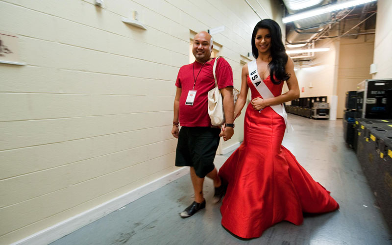 A handout picture provided by the Miss Universe Organization on 23 August 2010 shows Rima Fakih (R), Miss USA 2010, walking with Roston Ogata (L), Director Talent Development, backstage before the 2010 Miss Universe Presentation Show at Mandalay Bay Events Center in Las Vegas, Nevada, USA, 19 August 2010. (EPA)