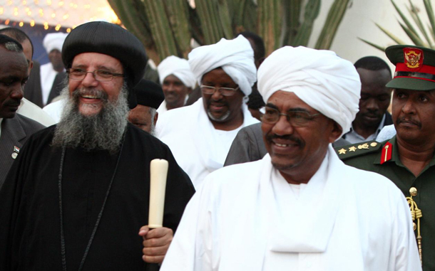 Sudan's President Omar Hassan al-Bashir (R) takes part in the annual Ramadan Iftar meal, held with members of the Sudanese Christian Orthodox community in Khartoum, Sudan. (EPA)