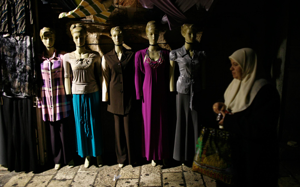 An Arab woman walks by a store selling modern women's clothes in Jerusalem's Old City. Muslims all over the world are celebrating the holy month of Ramadan, in which they abstain from eating, drinking and sexual relations from dusk to dawn. Ramadan is the holiest month in the Islamic calendar. (EPA)
