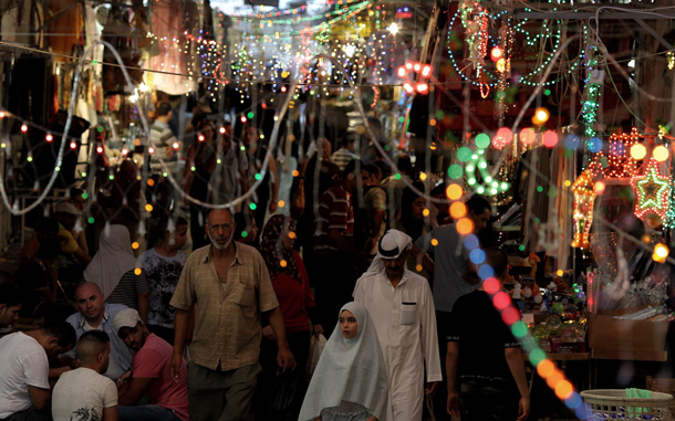 People stroll through a during Ramadan colorful lit market street in Jerusalem's Old City. Muslims all over the world are celebrating the holy month of Ramadan, in which they abstain from eating, drinking and sexual relations from dusk to dawn. Ramadan is the holiest month in the Islamic calendar. (EPA)