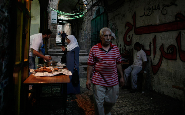 An Arab women buys food after sundown in Jerusalem's Old City. Muslims all over the world are celebrating the holy month of Ramadan, in which they abstain from eating, drinking and sexual relations from dusk to dawn. Ramadan is the holiest month in the Islamic calendar. (EPA)