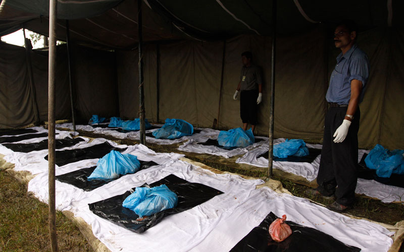 Remains of victims of a plane crash are laid on the ground for identification in Katmandu, Nepal, Tuesday. (AP)