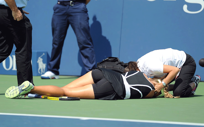 Victoria Azarenka of Belarus is attended to after collapsing as she played Gisela Dulko of Argentina (unseen) during their second round match at the 2010 US Open Tennis Championship at the USTA National Tennis Center in Flushing, Meadows, New York, USA. (EPA)