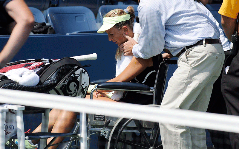 Victoria Azarenka of Belarus is wheeled off the court by officials after collapsing as she played Gisela Dulko of Argentina (unseen) during their second round match at the 2010 US Open Tennis Championship at the USTA National Tennis Center in Flushing, Meadows, New York, USA. (EPA)