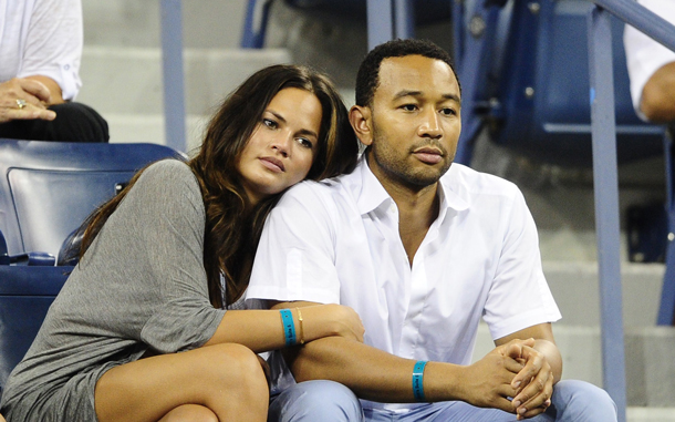 US singer John Legend and his girlfriend watch tennis player Andy Roddick returns a point to Serbia's Janko Tipsarevic, during their second round match at the 2010 US Open tennis tournament, in New York. (AFP)