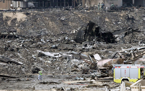 A United Arab Emirates (UAE) policeman walks at the site where a cargo airplane crashed while taking off from Dubai airport, United Arab Emirates. (EPA)