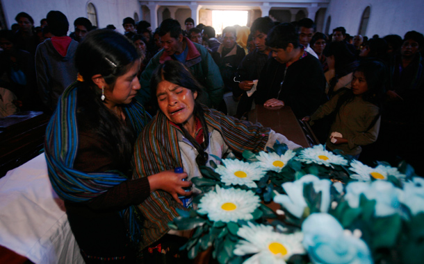 Quiche indigenous women grieve during a funeral mass for mudslide victims in Santa Maria Ixtahuacan, Guatemala. Torrential rains from a tropical depression caused landslides that have killed at least 38 people in Guatemala. (AP)