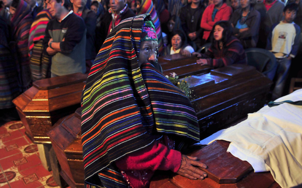 A woman cries next to a coffin of one of the victims of the strong rains that hit Guatemala at the church of Santa Catarina Ixtahucan, Guatemala. At least 37 died due to the rains in two days, at least 40 are missing and more than 40,000 were affected. (EPA)