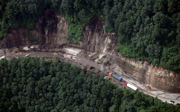 An aerial view shows the site of a landslide in La Cumbre de Alaska. As many as 100 people may have been buried in a landslide in Guatemala on a major highway, a spokesman for the fire department said on Sunday. Approximately 100 people were attempting to dig a bus out of a first mudslide when a second engulfed the scene, said fire department spokesman Sergio Vasquez. (REUTERS)