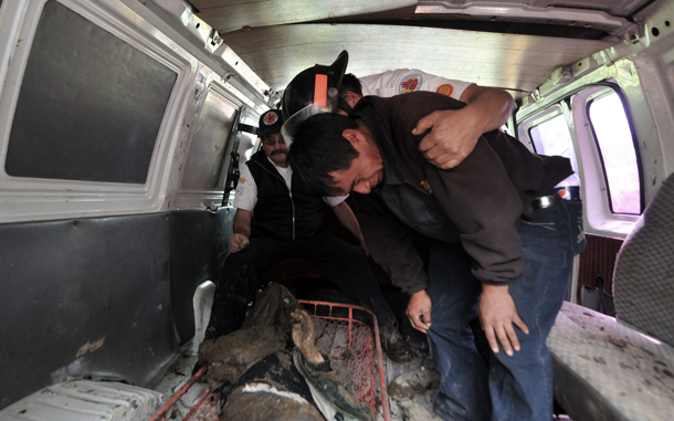 Manuel Ajtzalam cries before the corpse of his nephew Manuel Sohon, buried by a landslide in the Nahuala municipality, Solola, west of Guatemala City. Some 20 bodies have been retrieved in that place so far and there are still scores of missing people. The death toll from landslides in Guatemala rose to 36 on Sunday as the country's President Alvaro Colom declared the disaster a "national tragedy. (AFP)