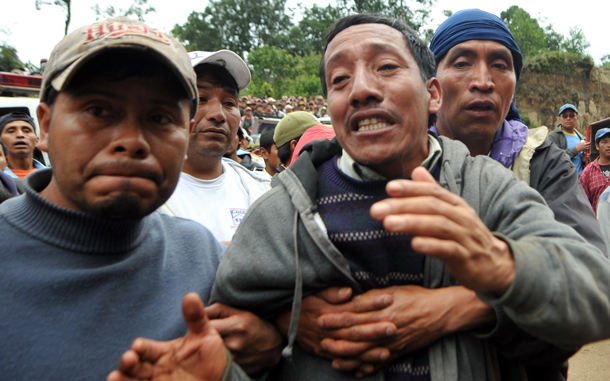 Manuel Jolom (C) cries after his son Walfred Manuel was buried by a landslide in the Nahuala municipality, Solola, west of Guatemala City. Some 20 bodies have been retrieved in that place so far and there are still scores of missing people. The death toll from landslides in Guatemala rose to 36 on Sunday as the country's President Alvaro Colom declared the disaster a "national tragedy. (AFP)