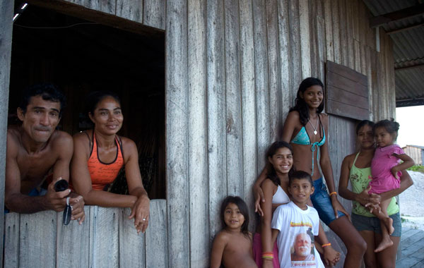 Fourteen-year-old Elisany Silva (3rd R), who measures 2.06 meters (6'9") tall poses with her friends and family as her mother Ana Maria Silva (2nd L) and her step-father Luiz Jorge (L) looks on in front of her house in Braganca in the Brazilian Amazon state of Para. (REUTERS)